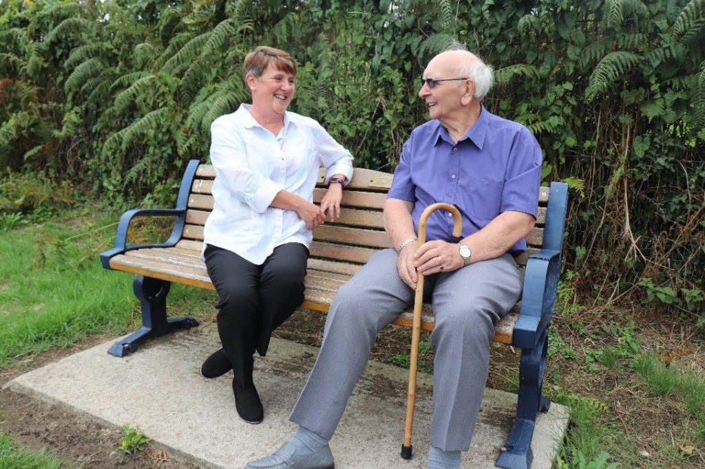 Care Worker sitting on a bench in Swansea