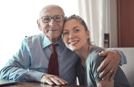 Happy elderly man being cared for by - Living at home